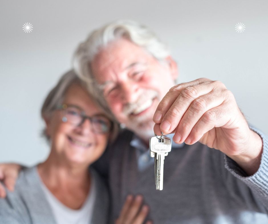 couple holding up a key