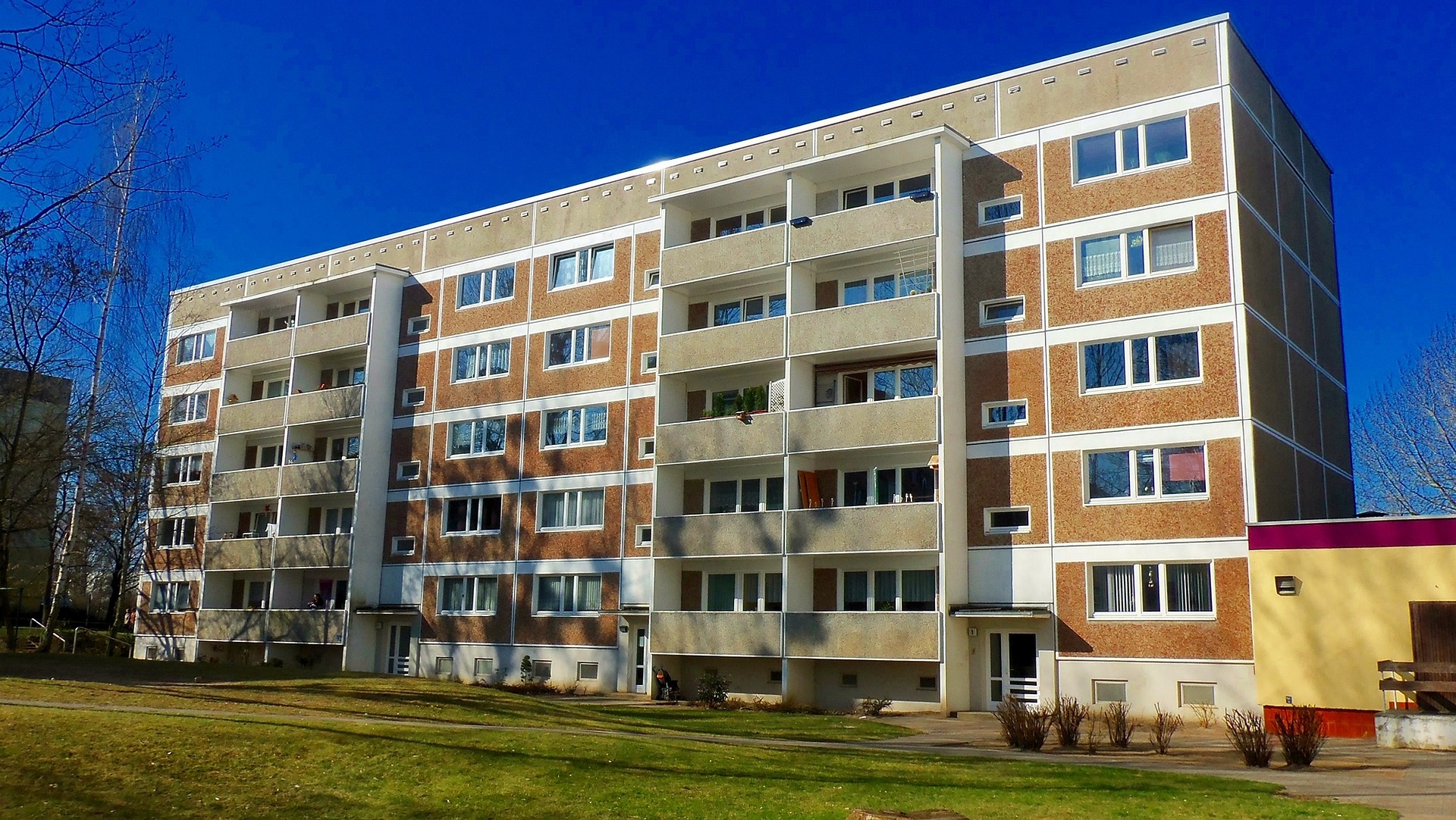 apartment building with small lawn in front